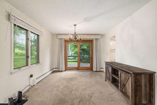 2055 Random Dr, Mansfield, OH 44904 - unfurnished dining area with baseboard heating, a chandelier, and light carpet