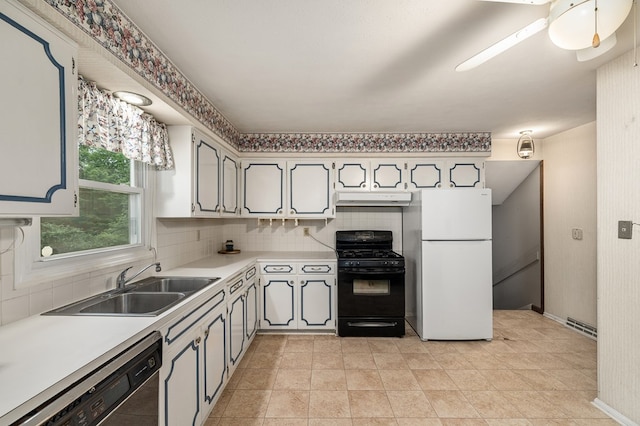 2055 Random Dr, Mansfield, OH 44904 - kitchen with freestanding refrigerator, dishwashing machine, black range with gas stovetop, under cabinet range hood, and light countertops
