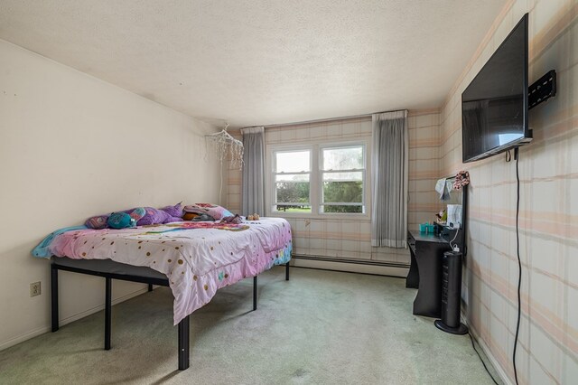 2055 Random Dr, Mansfield, OH 44904 - carpeted bedroom featuring a baseboard heating unit, a textured ceiling, and wallpapered walls
