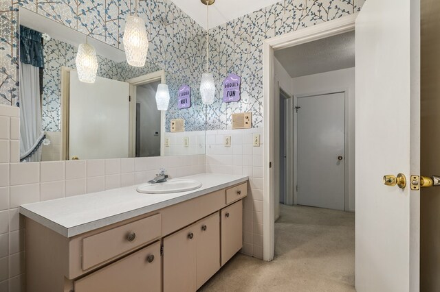 2055 Random Dr, Mansfield, OH 44904 - bathroom with wallpapered walls, tile walls, vanity, and a wainscoted wall
