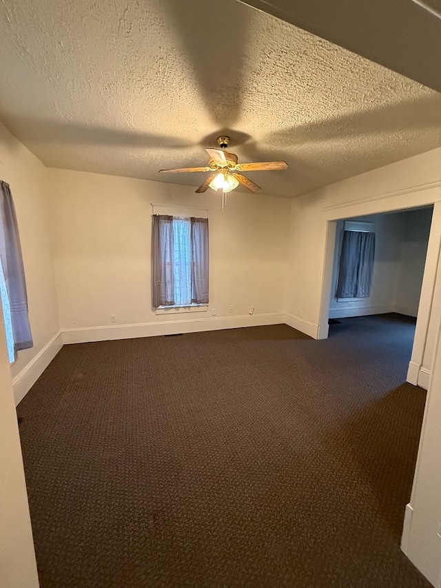 carpeted empty room with a textured ceiling and ceiling fan