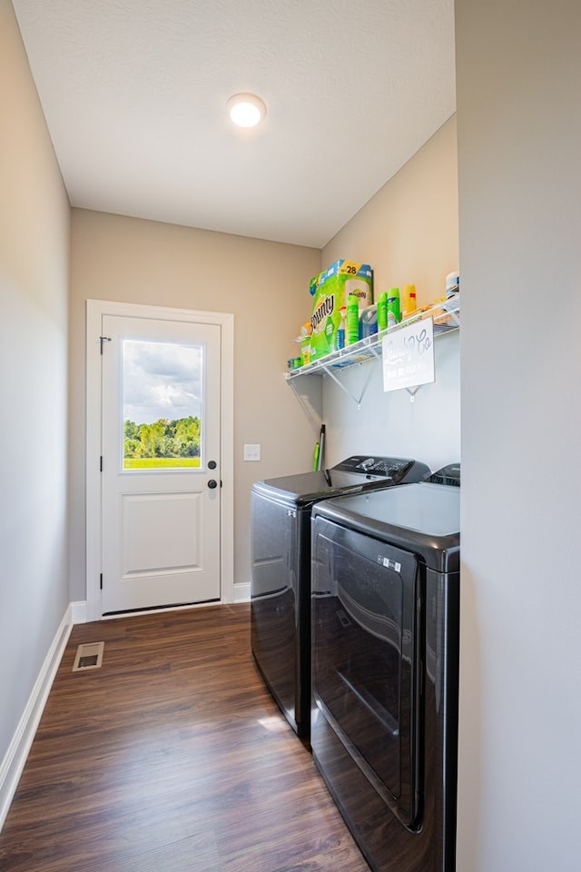 laundry room with dark hardwood / wood-style flooring and washer and clothes dryer