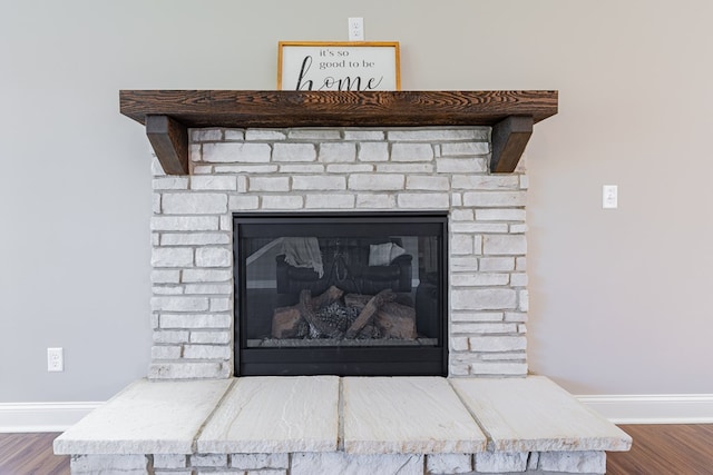 details with hardwood / wood-style floors and a fireplace