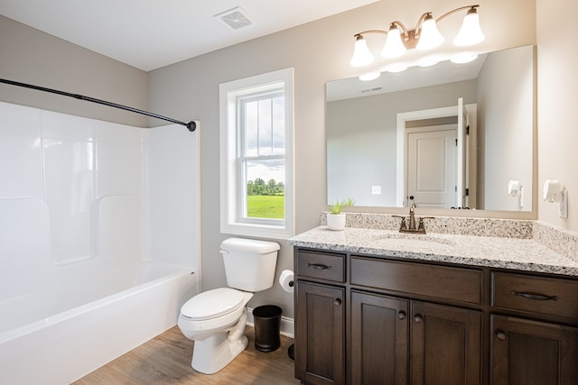 full bathroom featuring vanity, shower / bathing tub combination, hardwood / wood-style flooring, and toilet