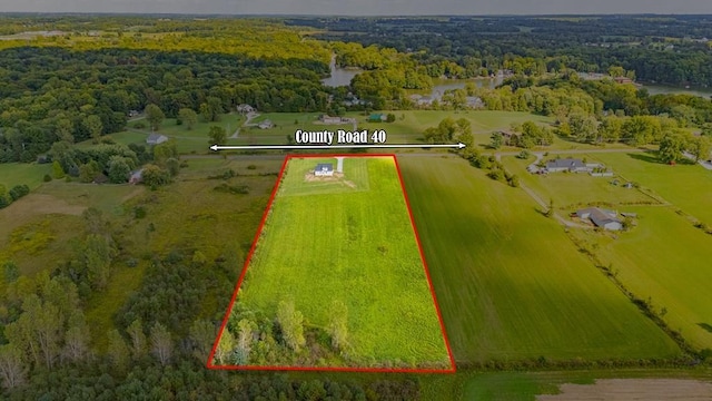 birds eye view of property with a rural view