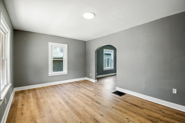 456 Park St, Marion, OH 43302 - empty room with arched walkways and light wood-style flooring