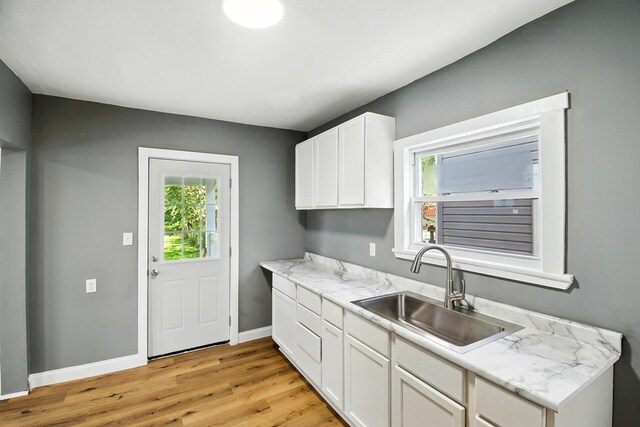 456 Park St, Marion, OH 43302 - kitchen with light wood-type flooring and white cabinetry