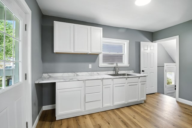 456 Park St, Marion, OH 43302 - kitchen featuring white cabinetry, healthy amount of natural light, light wood-type flooring, and light stone counters
