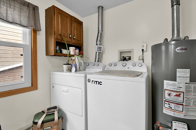28 W Main St, Hayesville, OH 44838 - washroom featuring separate washer and dryer, cabinet space, and gas water heater