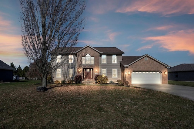 view of front of home featuring a yard and a garage