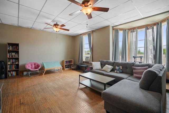 38 E Main St, Shelby, OH 44875 - living room featuring a drop ceiling, a ceiling fan, hardwood / wood-style flooring, and cooling unit