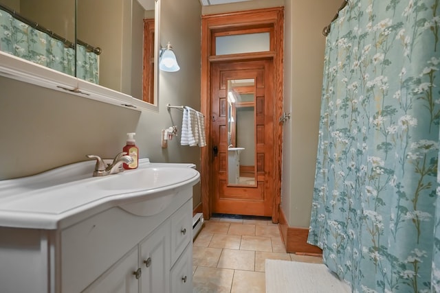 38 E Main St, Shelby, OH 44875 - bathroom featuring vanity, curtained shower, tile patterned floors, and a baseboard heating unit