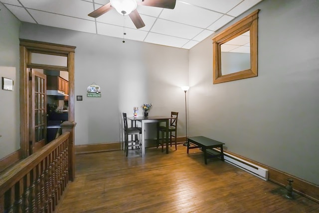 38 E Main St, Shelby, OH 44875 - dining space with a ceiling fan, a drop ceiling, wood-type flooring, and a baseboard heating unit