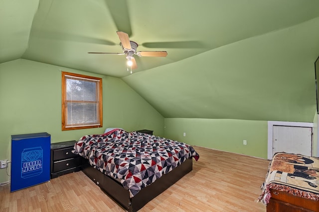 bedroom with light wood-type flooring, ceiling fan, and lofted ceiling