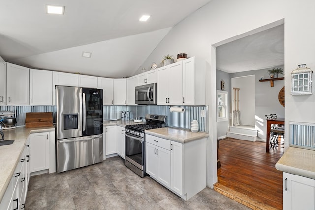 kitchen featuring decorative backsplash, white cabinetry, and appliances with stainless steel finishes