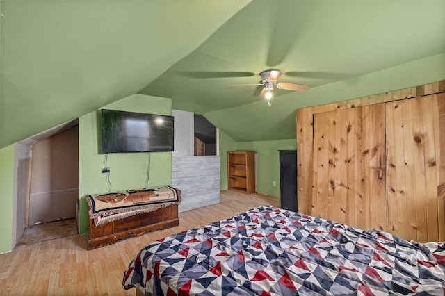 bedroom with ceiling fan, light hardwood / wood-style floors, and lofted ceiling