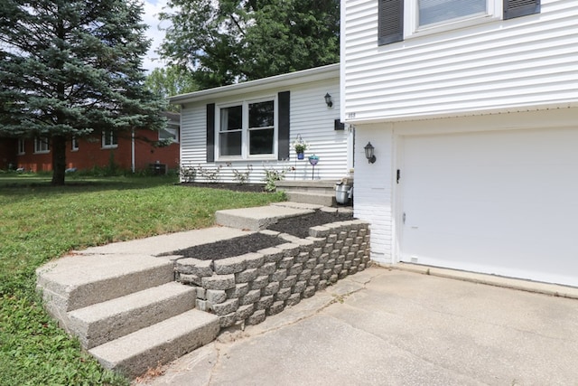 468 Clearview Rd, Mansfield, OH 44907 - view of exterior entry with a yard, a garage, and driveway