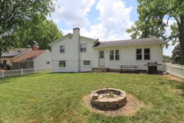 468 Clearview Rd, Mansfield, OH 44907 - rear view of property with a chimney, a fenced backyard, and an outdoor fire pit