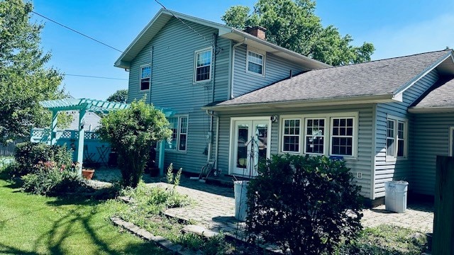 920 Woodbine St, Willard, OH 44890 - rear view of house with a chimney, a pergola, and a lawn