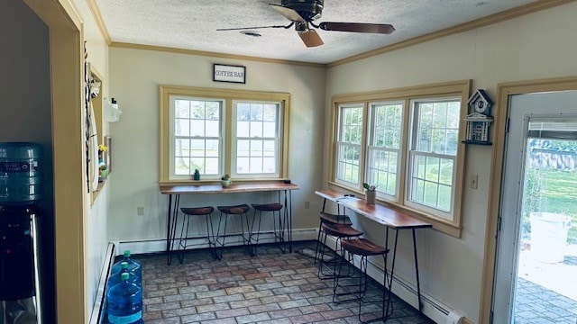 920 Woodbine St, Willard, OH 44890 - dining area with ornamental molding, plenty of natural light, ceiling fan, brick patterned floors, and a textured ceiling