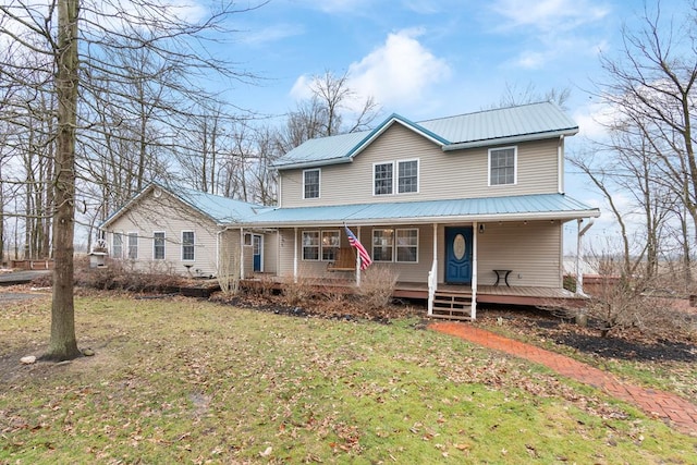 farmhouse inspired home featuring a porch and a front lawn