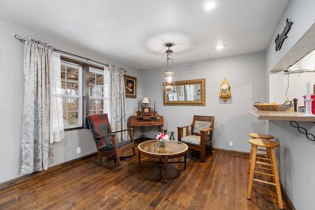 sitting room with dark wood-type flooring