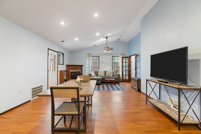 dining space with lofted ceiling, hardwood / wood-style floors, and ceiling fan