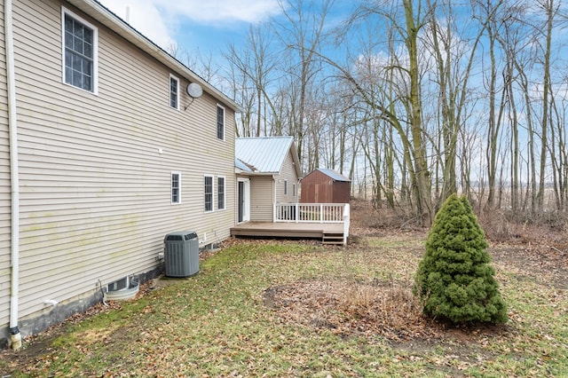 view of yard with cooling unit and a deck