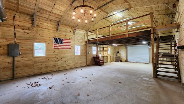 interior space featuring wooden ceiling, high vaulted ceiling, wooden walls, beamed ceiling, and a notable chandelier