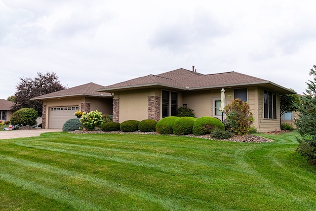 view of front of property with a garage and a front lawn