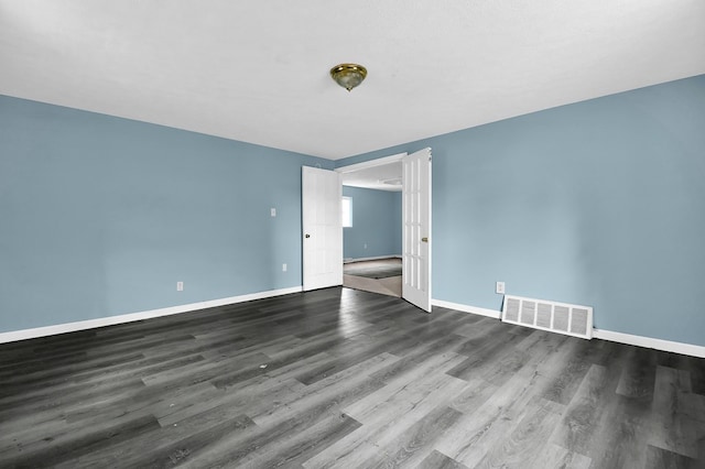 empty room with dark hardwood / wood-style floors