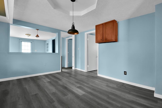 interior space with dark hardwood / wood-style flooring and a textured ceiling