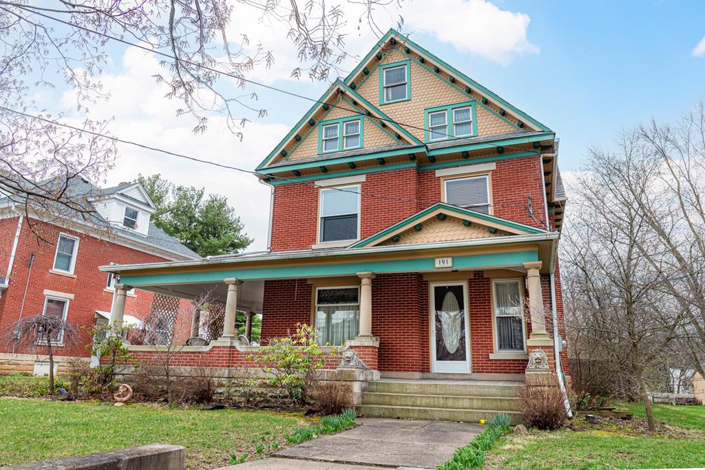 191 W High St, Mount Gilead, OH 43338 - victorian house featuring brick siding, a front lawn, and a porch