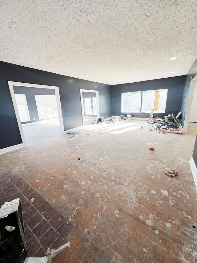 unfurnished living room with a textured ceiling