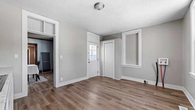 unfurnished bedroom featuring hardwood / wood-style floors and a textured ceiling