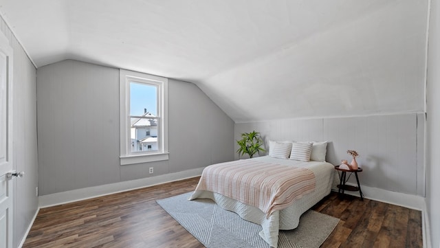 bedroom featuring dark hardwood / wood-style flooring and vaulted ceiling