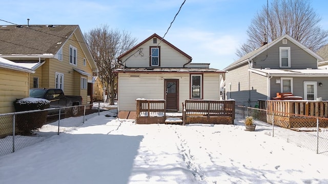 snow covered property featuring a wooden deck