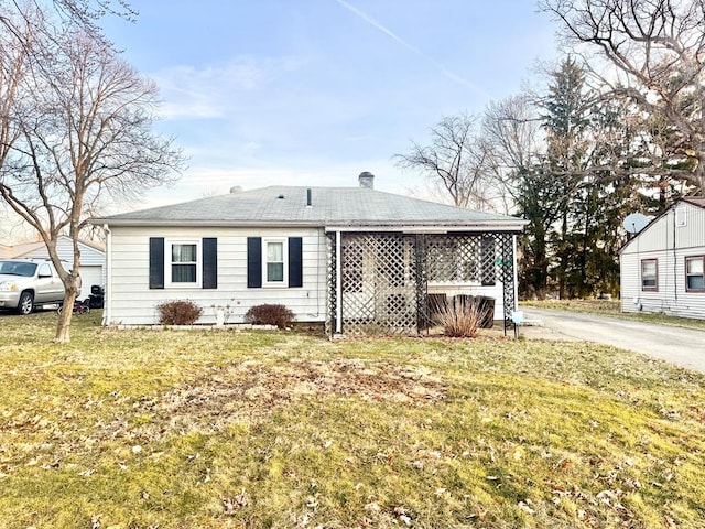 rear view of property with a yard and a chimney