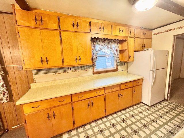 kitchen with light countertops and freestanding refrigerator