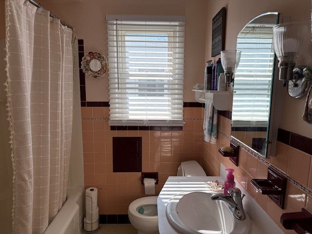 538 Broadview Ave, Mansfield, OH 44903 - bathroom featuring a sink, tile walls, healthy amount of natural light, toilet, and a wainscoted wall