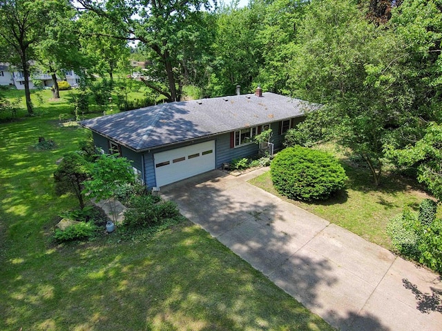 18373 Bentwood Dr, Doylestown, OH 44230 - single story home with concrete driveway, a front lawn, an attached garage, a shingled roof, and a chimney