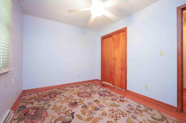 18373 Bentwood Dr, Doylestown, OH 44230 - spare room featuring a baseboard radiator, a ceiling fan, and wood finished floors