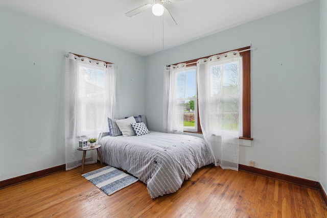 16.5 Monroe Ave, Shelby, OH 44875 - bedroom featuring multiple windows, baseboards, and hardwood / wood-style flooring