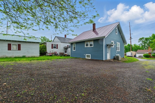 16.5 Monroe Ave, Shelby, OH 44875 - back of property with metal roof, a chimney, and cooling unit