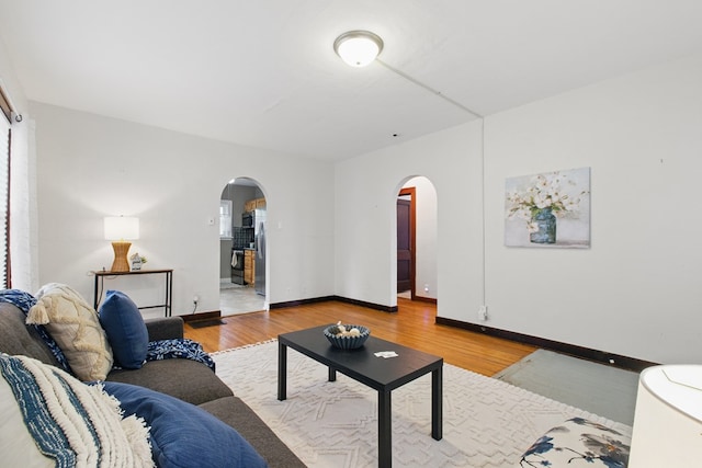 16.5 Monroe Ave, Shelby, OH 44875 - living area featuring arched walkways, wood finished floors, and baseboards