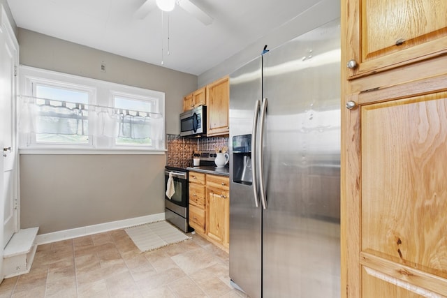 16.5 Monroe Ave, Shelby, OH 44875 - kitchen featuring stainless steel appliances, tasteful backsplash, baseboards, dark countertops, and ceiling fan