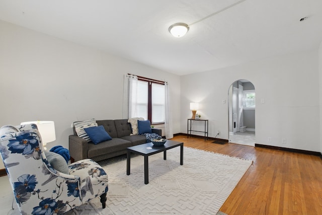 16.5 Monroe Ave, Shelby, OH 44875 - living room featuring arched walkways, wood finished floors, and baseboards