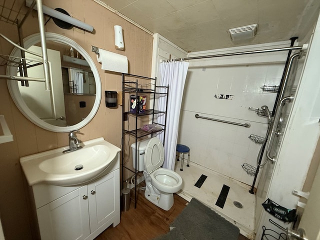 1015 N Cole St, Lima, OH 44805 - full bathroom with vanity, toilet, a shower stall, wood finished floors, and visible vents