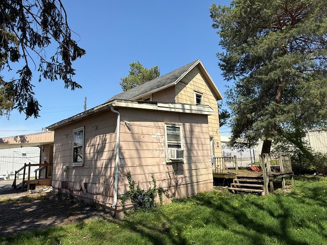 1015 N Cole St, Lima, OH 44805 - view of home's exterior with a lawn, a deck, and cooling unit