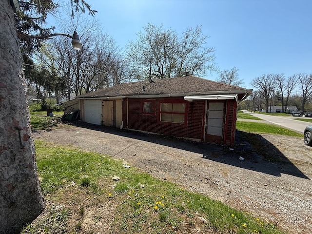 1015 N Cole St, Lima, OH 44805 - view of property exterior featuring brick siding, driveway, roof with shingles, and a garage